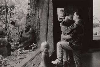 Couple Kissing in Front of Gorilla Cage